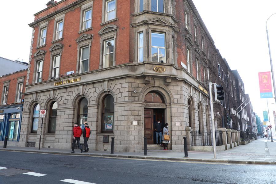 Watu wakitembea kutoka nje ya tawi la Benki ya Ireland jijini Dublin, Ireland, tarehe 1 Machi 2021. (Xinhua)